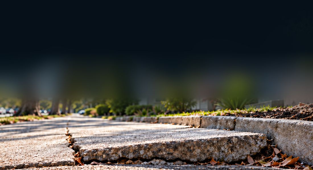 Cracked, uneven concrete sidewalk slab lifted at a seam
